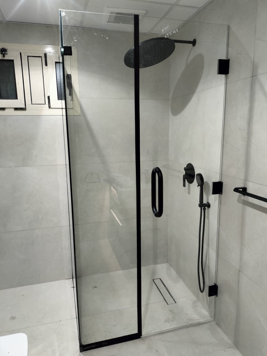 Frosted glass shower enclosure with chrome hinges